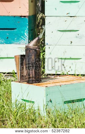 Closeup of bee smoker on crate at apiary