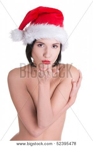 Sexy toples woman with perfect slim body wearing santa hat sending a kiss or blowing on hand