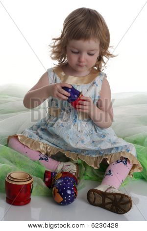 Little Girl Is Playing With Matreshka. Studio Shot