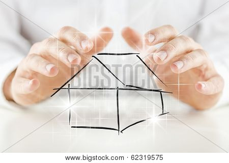 Man Protecting A House With His Hands