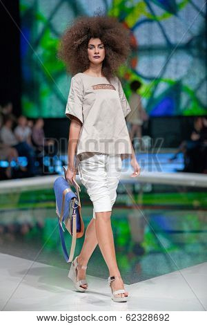 ZAGREB, CROATIA - MARCH 28, 2014: Fashion model wearing clothes designed by Marina Design and Marija Ivanovic bag on the 'Fashion.hr' fashion show