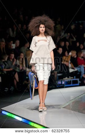 ZAGREB, CROATIA - MARCH 28, 2014: Fashion model wearing clothes designed by Marina Design and Marija Ivanovic bag on the 'Fashion.hr' fashion show