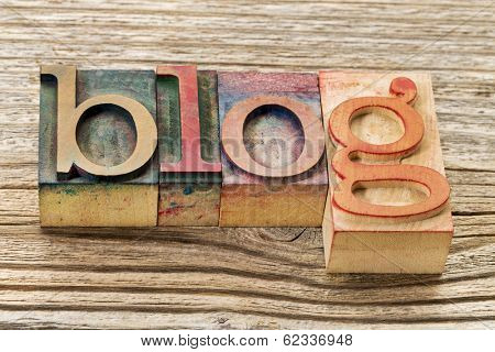 blog word in vintage letterpress wood stained by color inks type against grained  wood