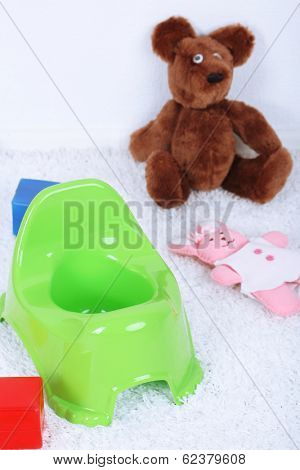 Green potty on home interior background