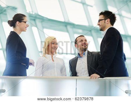 Group of businesspeople standing together in modern office