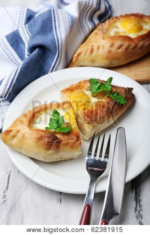 Ajarian khachapuri on wooden table