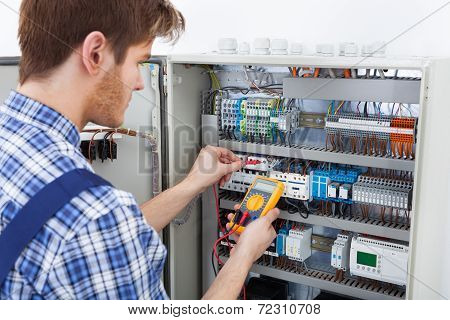Technician Examining Fusebox With Insulation Resistance Tester