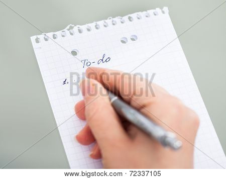 Hand With Pen Filling Out To Do List