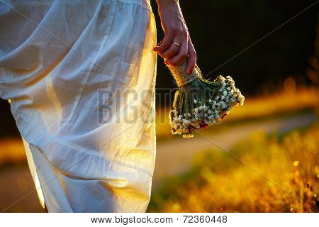 Young Woman In Field At Sunset