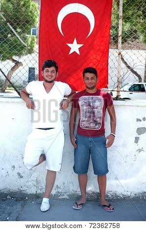Two teen Turkish boys with their national flag