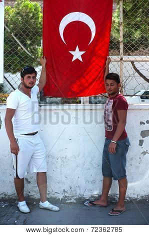 Two teen Turkish boys with their national flag