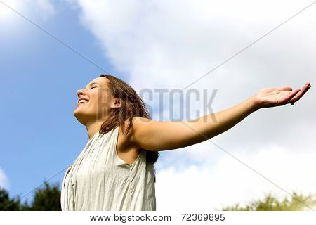 Carefree Woman Smiling With Arms Spread Open