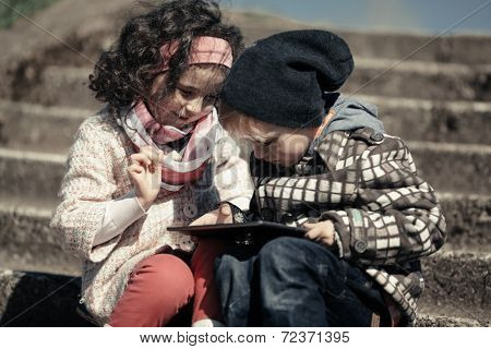 little girl and boy playing outdoor
