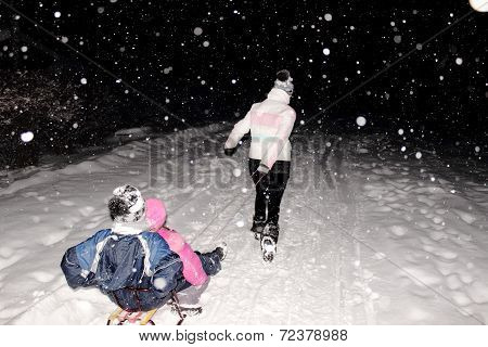 sledging at night in winter