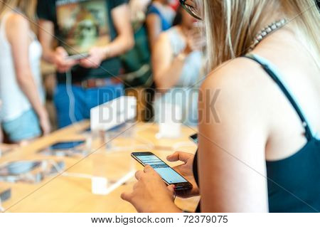 Young woman looks at her new iPhone 6