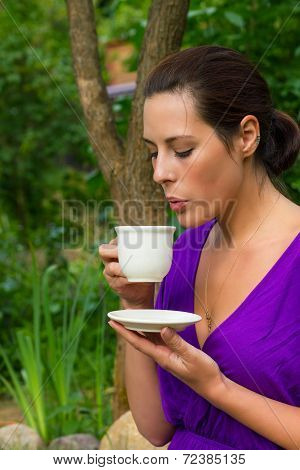 Beautiful Young Woman Drinking Coffee Outdoors