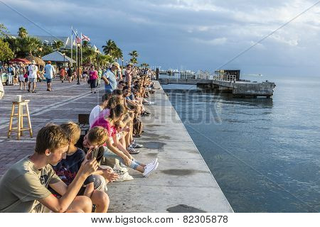 People Enjoy The Sunset Point At Mallory Square In Key Wes
