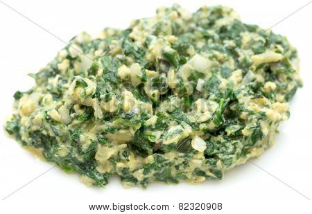Scrambled egg with spinach, onion and basil. Italian style uova strapazzate al verde, on a white plate.