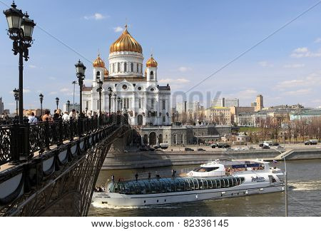 MOSCOW, RUSSIA - APRIL 24, 2011: Yacht of Flotilla Radisson Royal on the river against the Cathedral of the Christ the Savior. Working all year round, the Flotilla carry 500,000 passengers per year