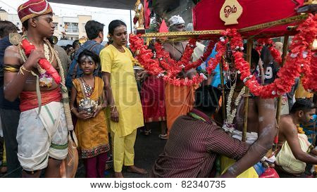KUALA LUMPUR, MALAYSIA - FEBRUARY 3, 2015: Hindu devotees wait to join a procession walking to the Batu Caves temple on Thaipusam day, a day of thanksgiving and devotion to Lord Muruga.