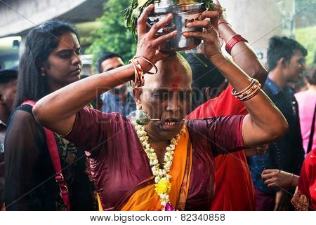 KUALA LUMPUR, MALAYSIA - FEBRUARY 3, 2015: Hindu devotees perform prayers at the Sri Mahamarriamman temple in Batu Caves. Hundreds of thousands of Hindu devotees come here for the Thaipusam prayers.