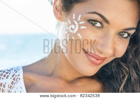 Carefree Young Woman With Suncream On Face At Beach
