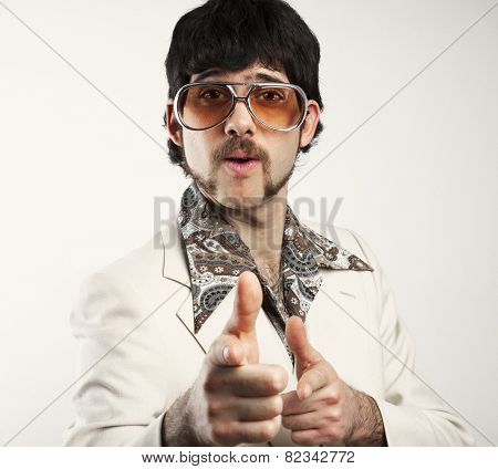 Instagram filtered image of a Retro 1970s man in a leisure suit pointing to the camera