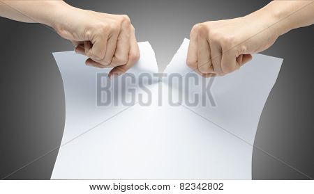 Woman Hand Ripping White Paper On Gray Background