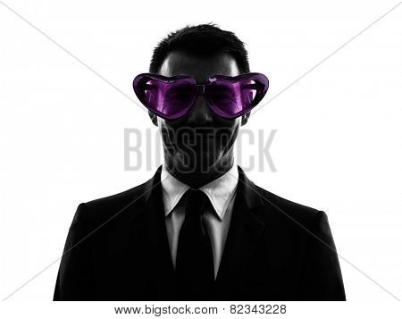 one caucasian business man loving with funny glasses in silhouette on white background
