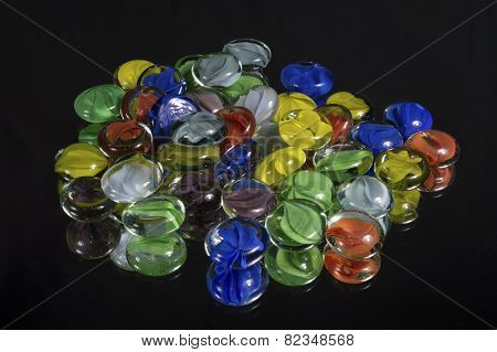 Colorful Cat-eye Marbles On Black Glass Mirror