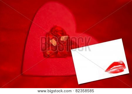 Rubies and paper red heart against white card