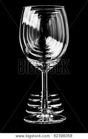 Empty wine glasses on a black background in vertical format