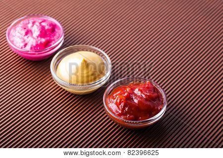 Adjika,mustard,horseradish In A Glass Bowl Close-up