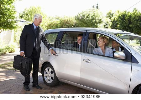 Group Of Business Colleagues Car Pooling Journey Into Work