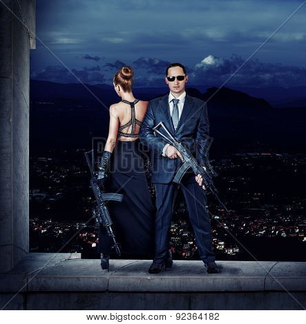 Fashionable Couple With Automatics
