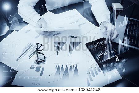 Sales Management Time Process.Photo trader work market report documents.Use electronic devices.Work graphics icons, stock exchanges reports interfaces.Business project startup.Horizontal, black white