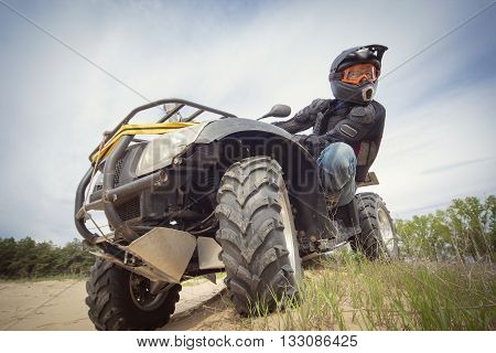 Racing ATV on the sand in summertime.