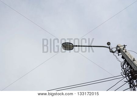 Electricity post and street light with the cloudy sky