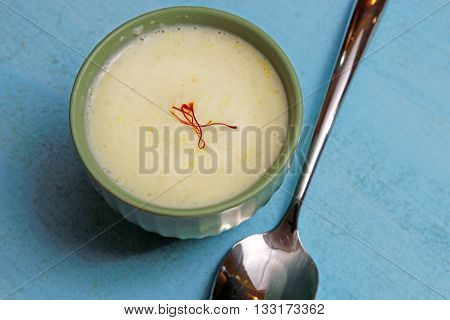 A bowl of Phirini an Indian dessert made of coarsely ground rice cooked in milk
