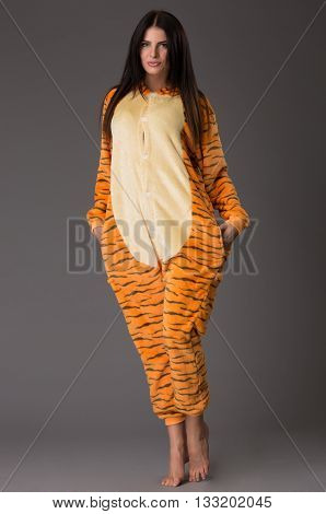 Happy woman in pajamas over greu background