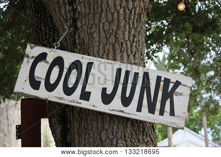 Cool Junk Sign hanging from tree in Texas