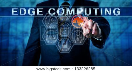 Business person is touching EDGE COMPUTING on an interactive virtual control display. Information technology metaphor and business concept for resource intensive distributed computing services.