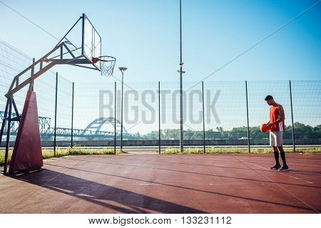 Young male basketball player taking a free throw.