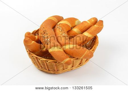 scuttle of fresh bread rolls on white background