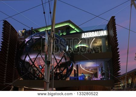 MILAN, ITALY - JUNE 29 2015: Night view of Azerbaijan Pavilion at Expo 2015 in Milan Universal exhibition on the theme of food with people inside. Image taken on June 29 2015.