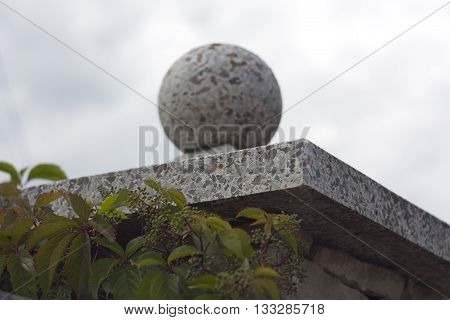 Marble ball on a background of blue sky entwined plants
