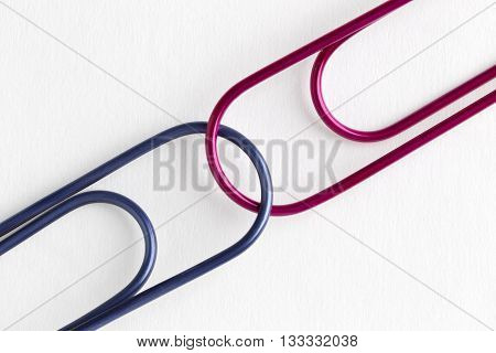red and blue paper clips isolated on a white background
