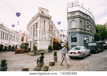 Tbilisi, Georgia - May 19, 2016: Young Man Goes On A Background Of Jan Shardeni And Rkinis Rigi Street In Tbilisi, Georgia