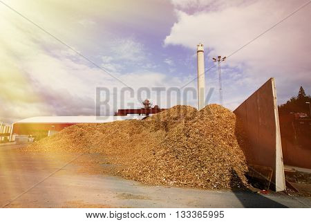 Bio Power Plant With Storage Of Wooden Fuel (biomass) Against Blue Sky