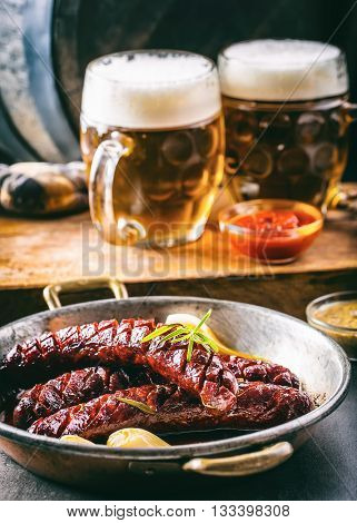 Sausage. Roasted chorizo sausage. Roasted spicy sausage chorizo home hotel or restaurant with beer vine brandy cognac whiskey. Still life. Toned photo.